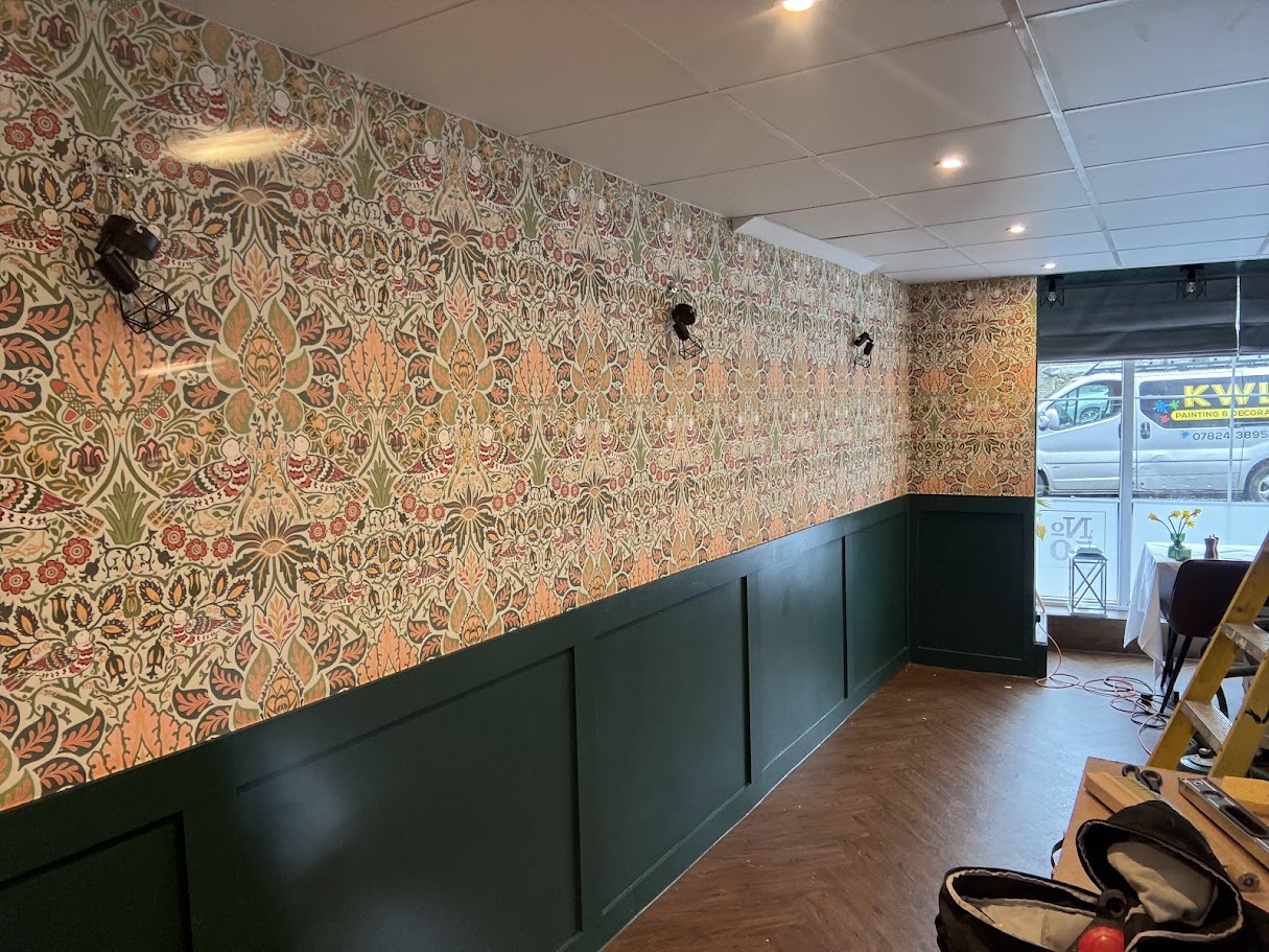 Feature wallpaper and green wainscoting